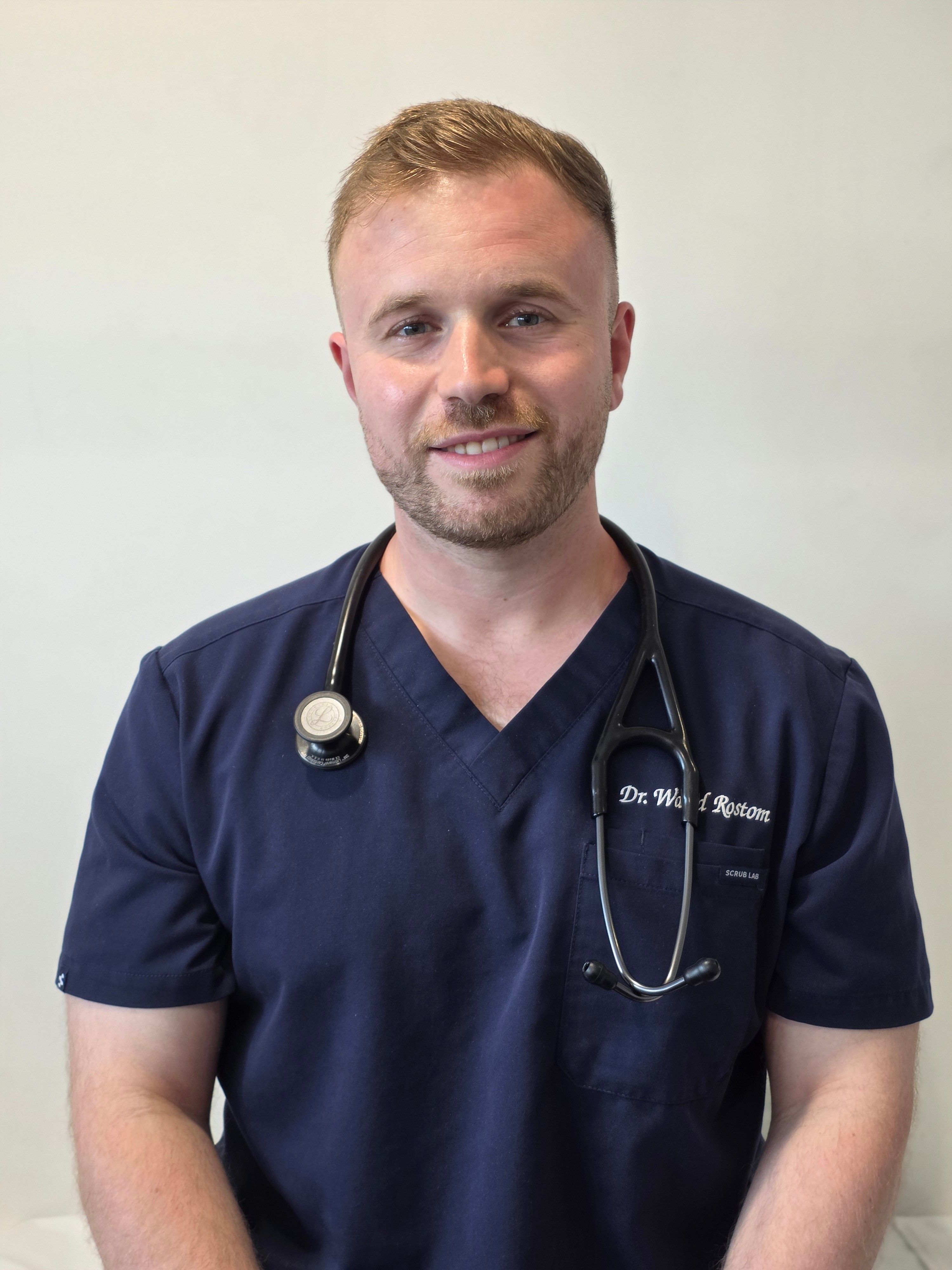 Stylized blue duotone portrait of a person facing the camera with arms crossed